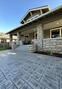 Grey stamped concrete patio - craftsman home with fall foliage background