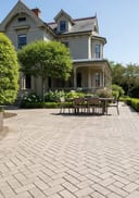 Herringbone brick patio - colonial home with garden edge setting