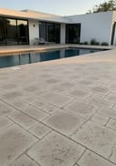 Travertine pool deck - overcast light showcasing stone texture detail