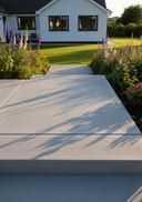 Light grey raw poured concrete open front stoop, white rendered bungalow, late afternoon